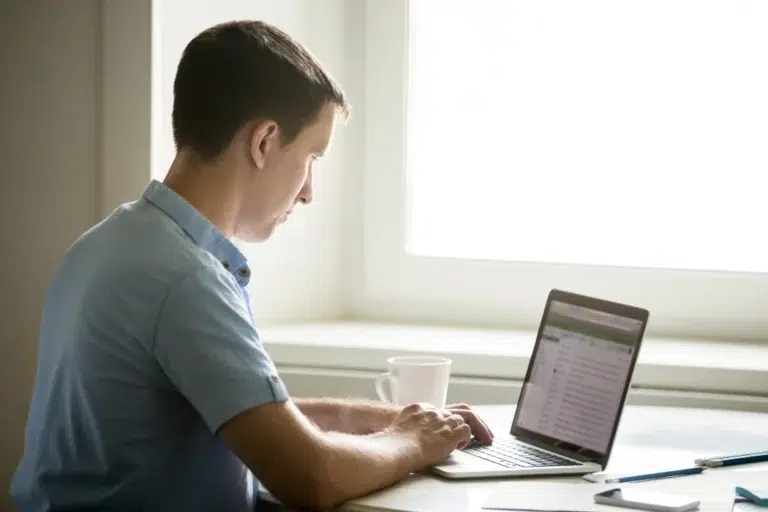 profile-portrait-young-man-working-desk-with-laptop
